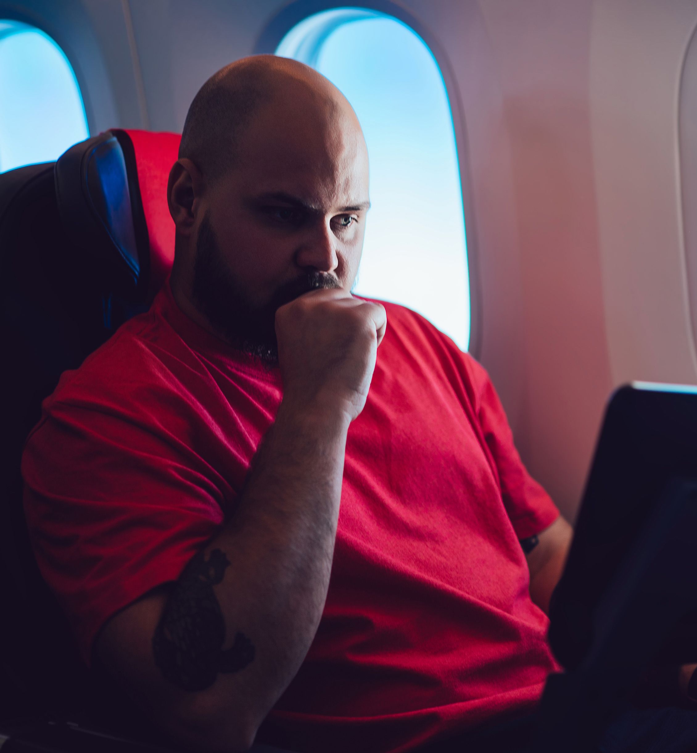 Man watching sports on plane